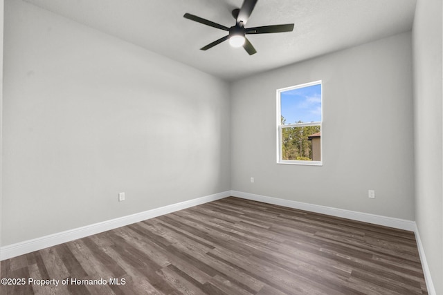 16113 Penn State Rd, Weeki Wachee, FL 34614 - spare room with dark wood-type flooring and a ceiling fan