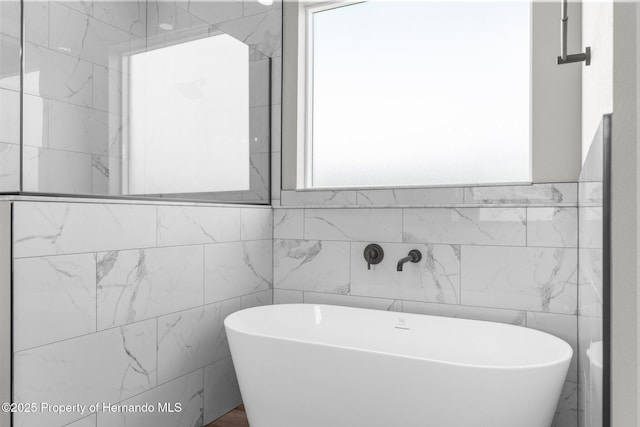 16113 Penn State Rd, Weeki Wachee, FL 34614 - full bath featuring tile walls and a freestanding tub