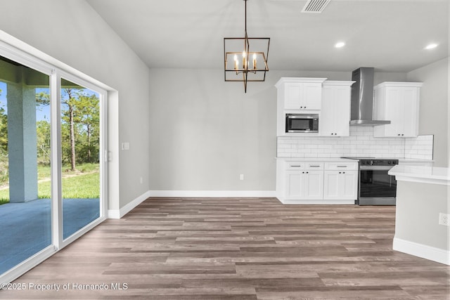 16113 Penn State Rd, Weeki Wachee, FL 34614 - kitchen with appliances with stainless steel finishes, wall chimney exhaust hood, decorative backsplash, white cabinetry, and light wood-style floors