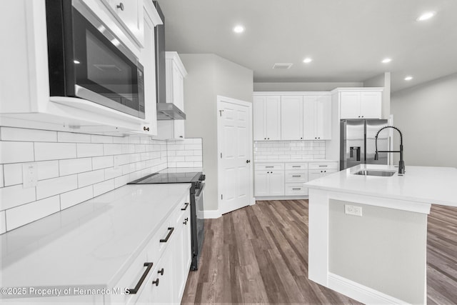 16113 Penn State Rd, Weeki Wachee, FL 34614 - kitchen with stainless steel appliances, dark wood-type flooring, tasteful backsplash, white cabinets, and recessed lighting
