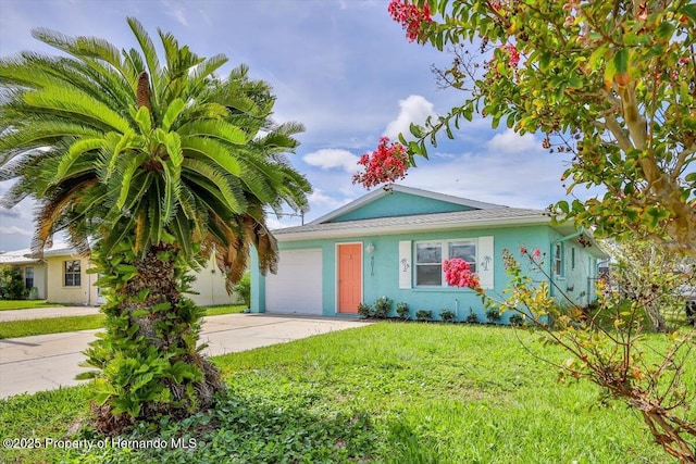 4016 Centavo Ct, Hernando Beach, FL 34607 - view of front of property featuring an attached garage, concrete driveway, stucco siding, and a front yard