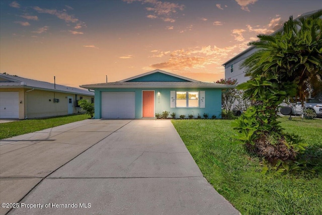 4016 Centavo Ct, Hernando Beach, FL 34607 - ranch-style house with driveway, a garage, a front yard, and stucco siding