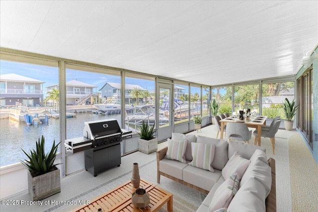 4016 Centavo Ct, Hernando Beach, FL 34607 - sunroom with plenty of natural light, a wall of windows, a water view, and carpet