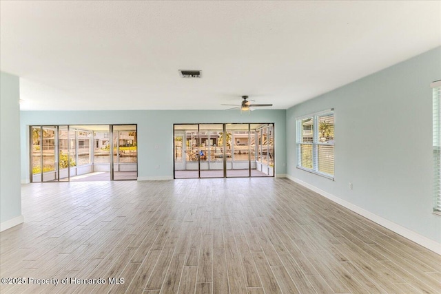 4016 Centavo Ct, Hernando Beach, FL 34607 - unfurnished living room featuring a ceiling fan and light wood-style floors