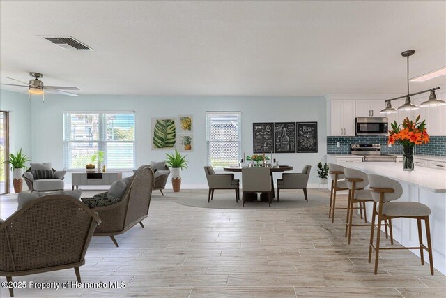 4016 Centavo Ct, Hernando Beach, FL 34607 - dining space with light wood-type flooring and ceiling fan