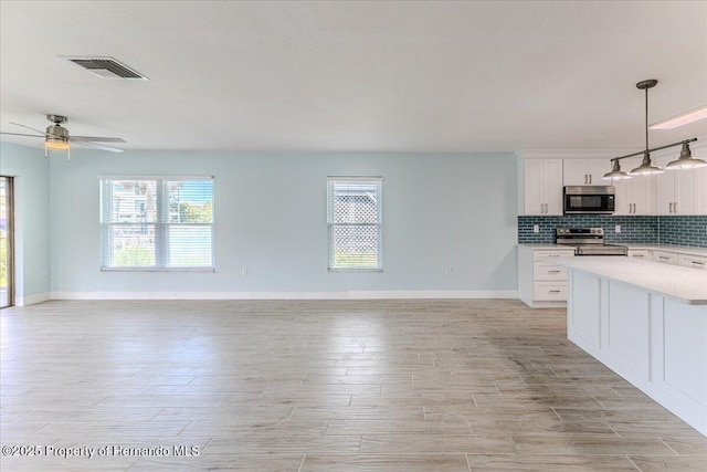 4016 Centavo Ct, Hernando Beach, FL 34607 - kitchen featuring stainless steel appliances, open floor plan, light countertops, and ceiling fan