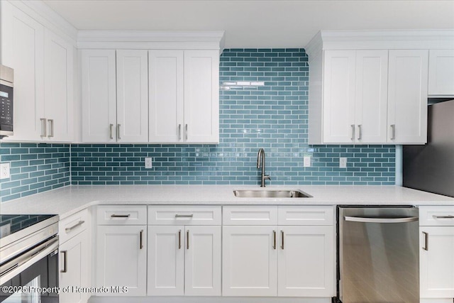 4016 Centavo Ct, Hernando Beach, FL 34607 - kitchen featuring dishwasher, light countertops, white cabinets, and decorative backsplash