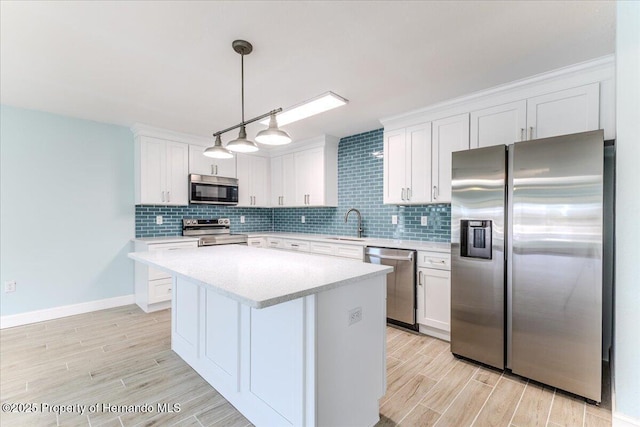 4016 Centavo Ct, Hernando Beach, FL 34607 - kitchen featuring appliances with stainless steel finishes, light countertops, light wood-type flooring, and white cabinets