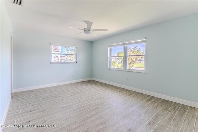 4016 Centavo Ct, Hernando Beach, FL 34607 - spare room with light wood-type flooring, plenty of natural light, and a ceiling fan