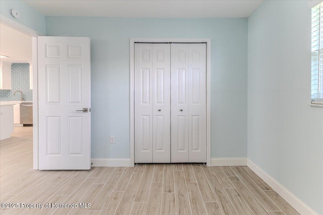 4016 Centavo Ct, Hernando Beach, FL 34607 - unfurnished bedroom featuring light wood finished floors and a closet