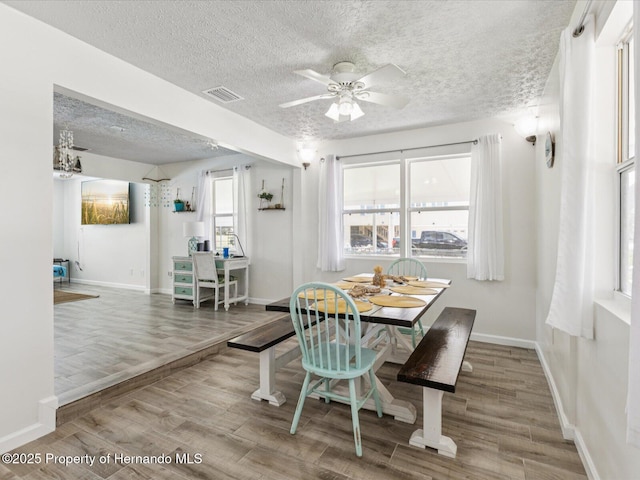 3579 Eagle Nest Dr, Hernando Beach, FL 34607 - dining area with a textured ceiling, wood finished floors, and ceiling fan