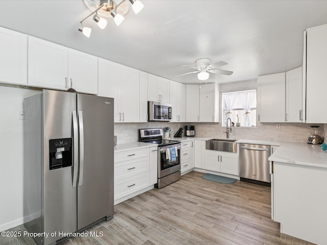 3579 Eagle Nest Dr, Hernando Beach, FL 34607 - kitchen featuring appliances with stainless steel finishes, tasteful backsplash, ceiling fan, and white cabinets