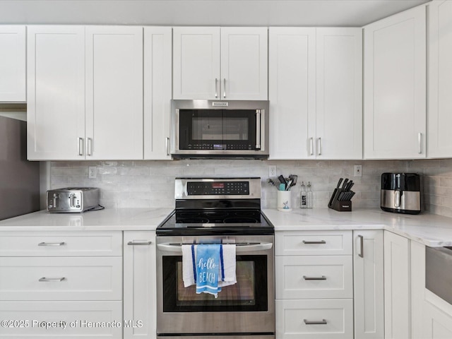 3579 Eagle Nest Dr, Hernando Beach, FL 34607 - kitchen featuring stainless steel appliances and white cabinetry