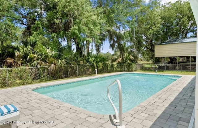 3579 Eagle Nest Dr, Hernando Beach, FL 34607 - view of pool with a fenced backyard, a patio, and view of scattered trees