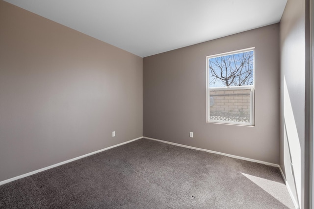 empty room with baseboards and carpet flooring