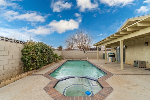 view of pool with a patio, a fenced backyard, and a pool with connected hot tub