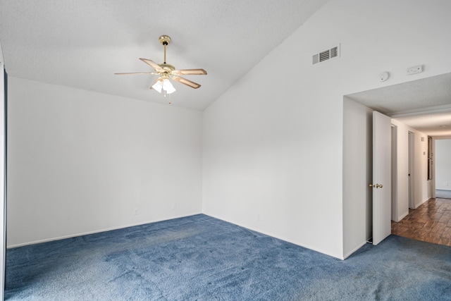 empty room with visible vents, lofted ceiling, carpet floors, a textured ceiling, and a ceiling fan