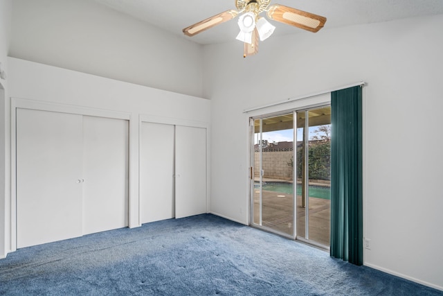 unfurnished bedroom featuring two closets, carpet, ceiling fan, and access to outside