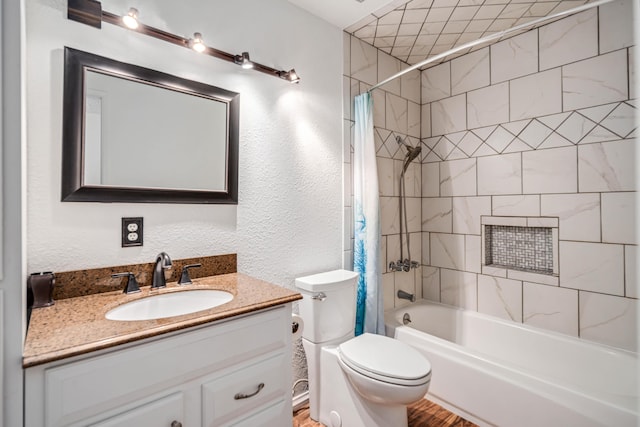 full bathroom with toilet, vanity, shower / tub combo with curtain, and a textured wall