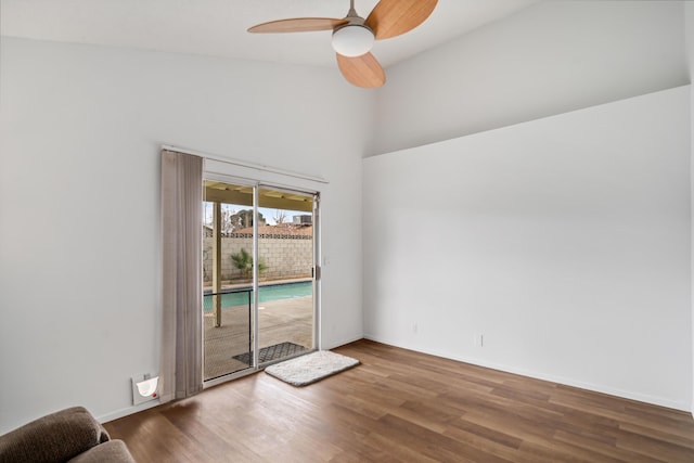 unfurnished room featuring wood finished floors, baseboards, and ceiling fan