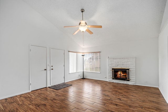 unfurnished living room featuring baseboards, a fireplace, wood finished floors, a textured ceiling, and a ceiling fan