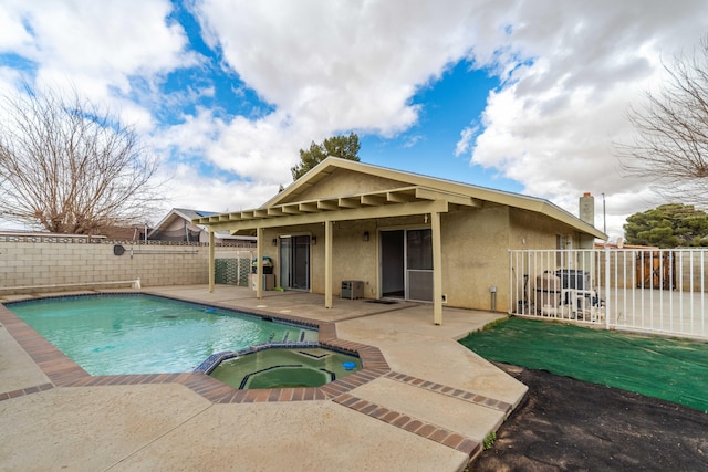 view of pool featuring a patio, a fenced backyard, and a pool with connected hot tub