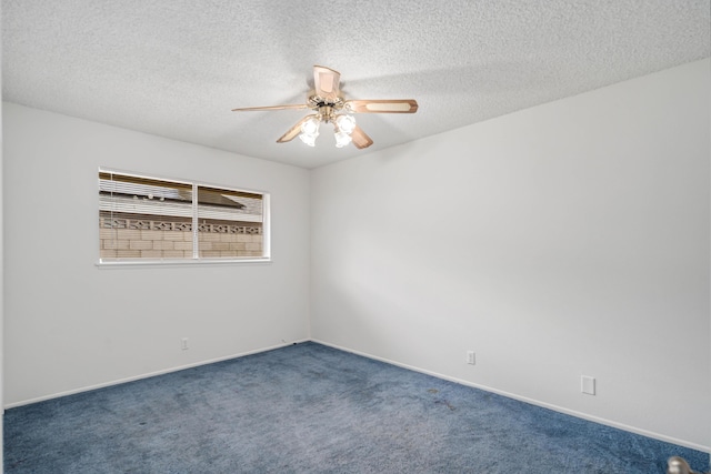 carpeted spare room featuring baseboards, a textured ceiling, and a ceiling fan