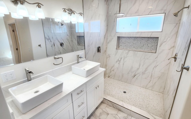 full bathroom with marble finish floor, double vanity, a sink, and a marble finish shower
