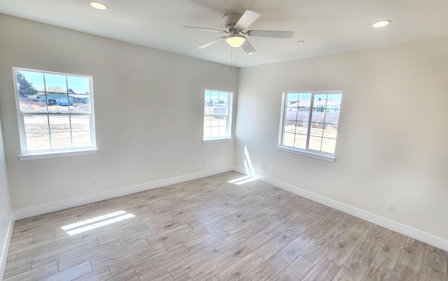 empty room with baseboards, light wood-style flooring, and recessed lighting