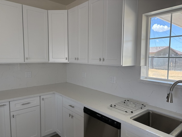 kitchen featuring white cabinets, a sink, and stainless steel dishwasher