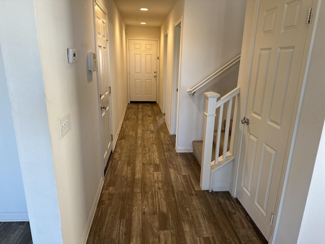 hall featuring dark wood finished floors, stairs, recessed lighting, and baseboards