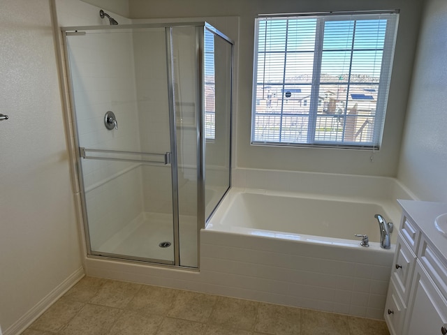 bathroom with vanity, tile patterned floors, a bath, and a stall shower