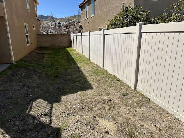 view of yard with a residential view and a fenced backyard