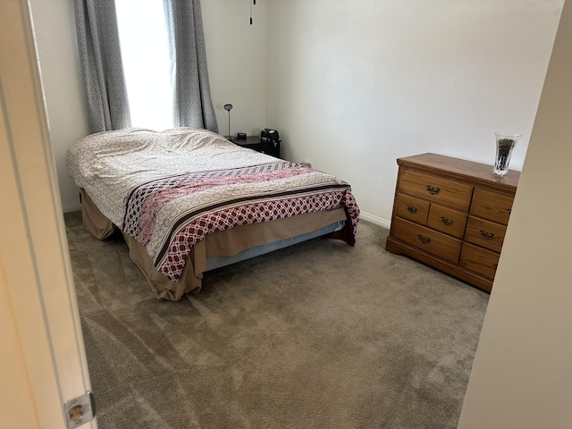 bedroom featuring baseboards and carpet flooring