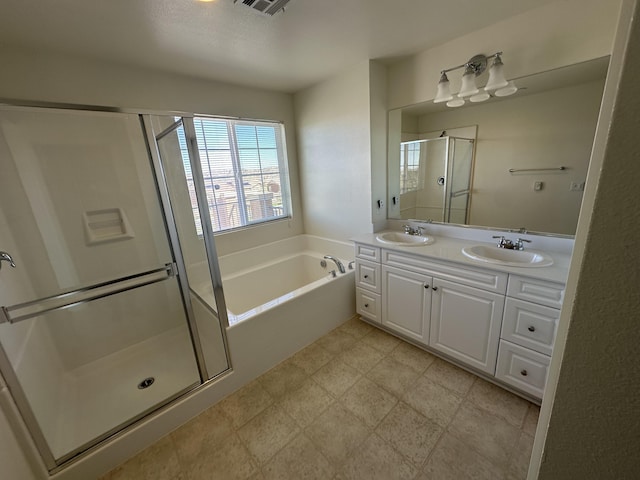 bathroom featuring double vanity, a shower stall, a garden tub, and a sink