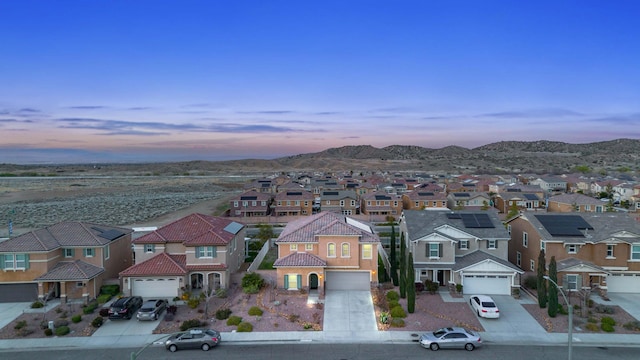 birds eye view of property with a mountain view and a residential view