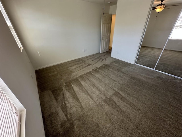 unfurnished bedroom featuring a closet, baseboards, and carpet flooring