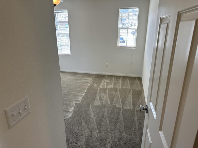 carpeted spare room with baseboards