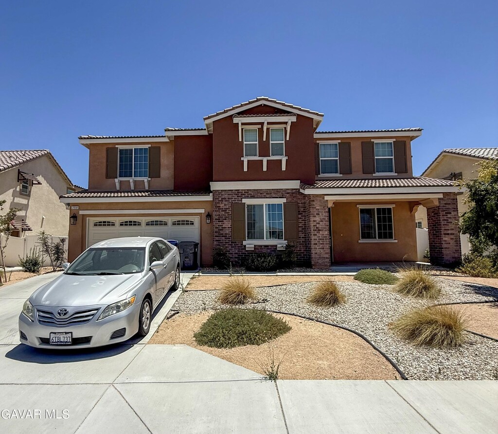 2050 Helconia Ct, Palmdale, CA 93551 - view of front of house with driveway, stucco siding, and a tiled roof