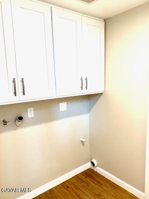 3503 Glenridge Ave, Rosamond, CA 93560 - washroom with cabinet space and dark wood-type flooring