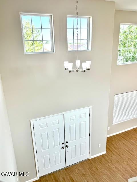 3503 Glenridge Ave, Rosamond, CA 93560 - foyer with a chandelier, a high ceiling, and wood finished floors