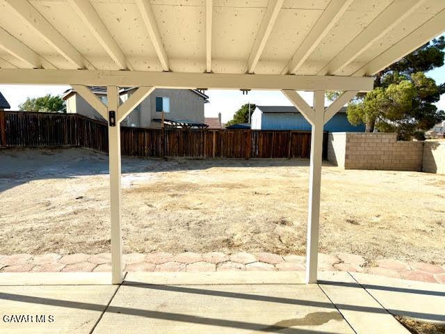 3503 Glenridge Ave, Rosamond, CA 93560 - fenced backyard with a patio area and a carport