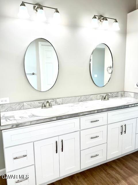 3503 Glenridge Ave, Rosamond, CA 93560 - bathroom featuring double vanity and wood finished floors