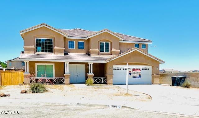 3503 Glenridge Ave, Rosamond, CA 93560 - traditional-style house with driveway, covered porch, and stucco siding