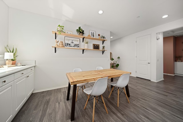 dining area with baseboards, dark wood-type flooring, and recessed lighting