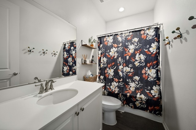 full bath with wood finished floors, curtained shower, vanity, and toilet