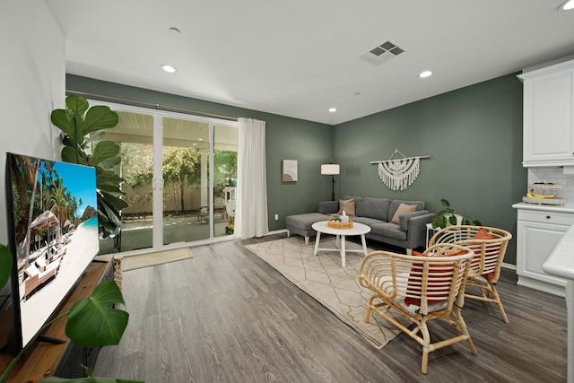 living area with baseboards, dark wood-style flooring, visible vents, and recessed lighting