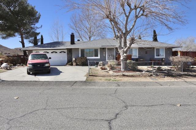 ranch-style home featuring a garage, driveway, a fenced front yard, and a chimney