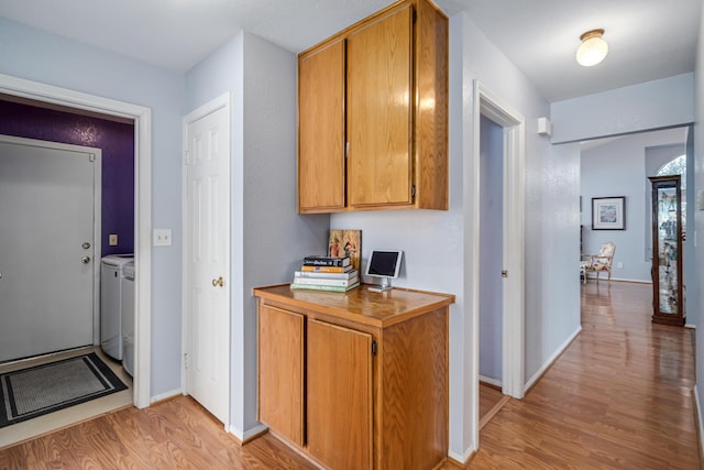 kitchen featuring washer and clothes dryer and light wood-type flooring