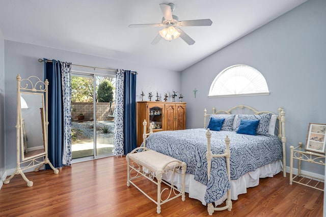 bedroom with access to exterior, ceiling fan, wood-type flooring, and lofted ceiling